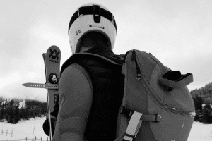 Skiezy video thumbnail showing ski carry straps in use for transport with a professional skier